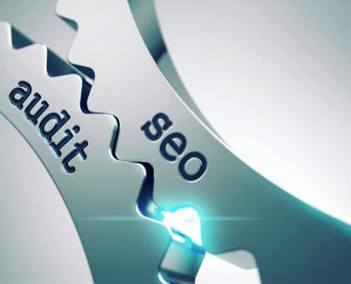 Two wheel cogs intersecting with the words "SEO" and "Audit" coming together.