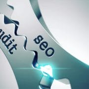 Two wheel cogs intersecting with the words "SEO" and "Audit" coming together.