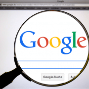A magnifying glass over the word Google that is displayed on Google's search page.