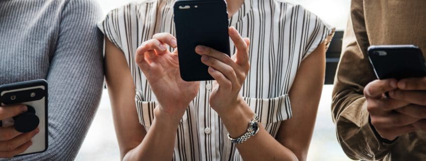 Three people on their smartphones.