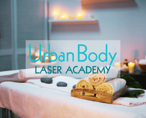 Urban Body Laser Academy featured image of Massage table with towels and hot rocks.