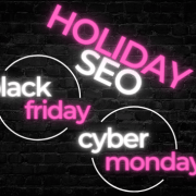 Holiday SEO, Black Friday, Cyber Monday words in neon over a black brick wall.
