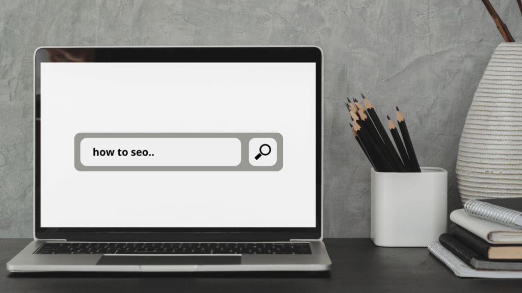 Laptop computer with "how to SEO" on the screen