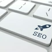 SEO letters with picture of Rocket ship painted on a keyboard enter button