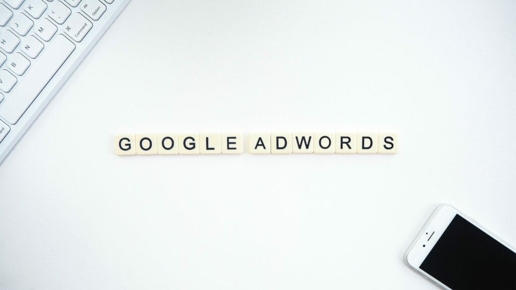 Google Adwords spelled out with Scrabble Letters - next to smart phone