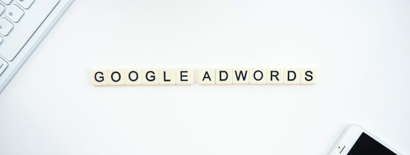 Google Adwords spelled out with Scrabble Letters - next to smart phone