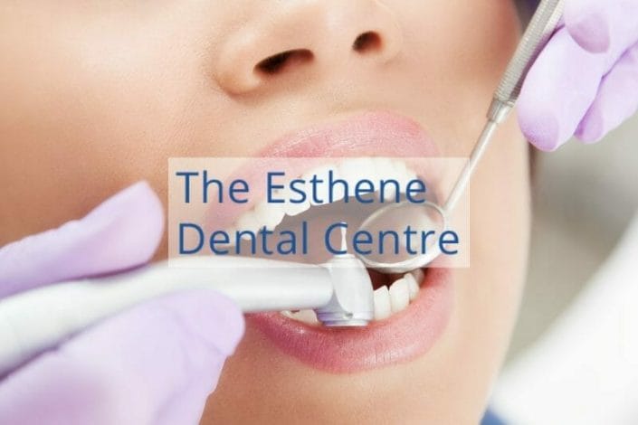 The Esthene Dental Centre featured image showing dentist checking a patient's teeth.