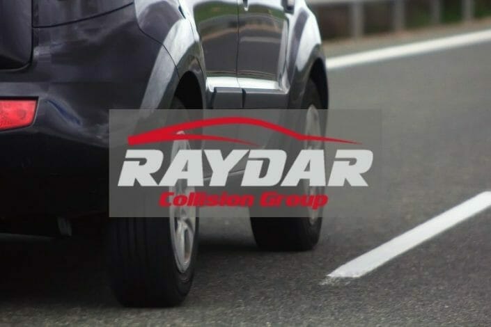 Raydar Collision Group logo over image of a vehicle on the road
