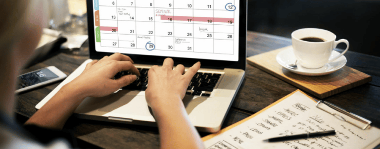 Person with a laptop working on a calendar