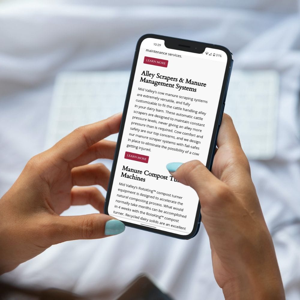 Female hands holding a cell phone that is displaying a website