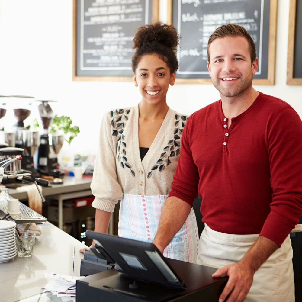 Young couple at the cash register at a restaurant
