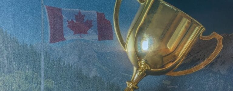A golden trophy is prominently displayed in the foreground, with the Canadian flag visible in the background against a blue sky. The flag features a red maple leaf on white, flanked by red bars. Mountain landscapes are faintly visible behind the flag.