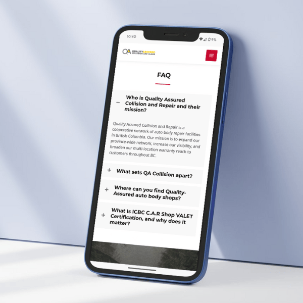 A smartphone displays a FAQ page from a website labeled "QA Quality Assured Collision and Repair." It features questions about the service, their uniqueness, certification, and importance. The phone is placed upright on a light surface.