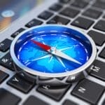 compass on top of laptop