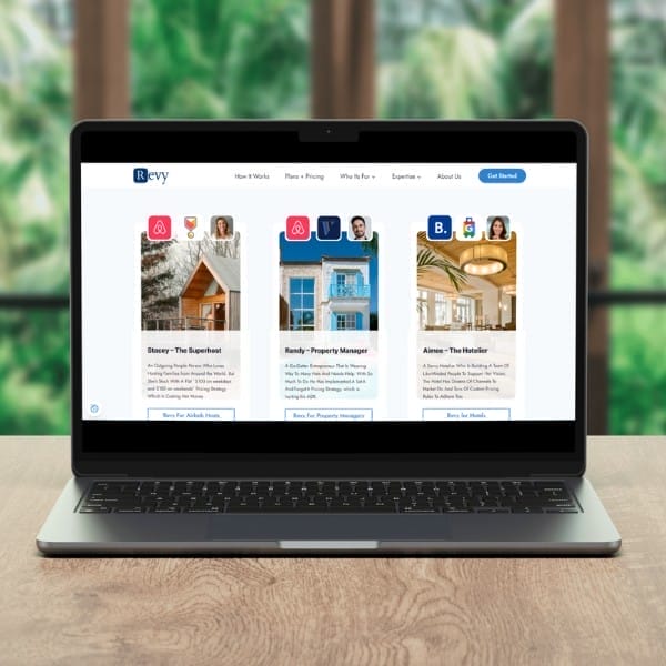 A laptop displaying a property management website with user profiles. The screen shows three profiles with images and accompanying text. The background is blurred with green foliage visible through a large window.