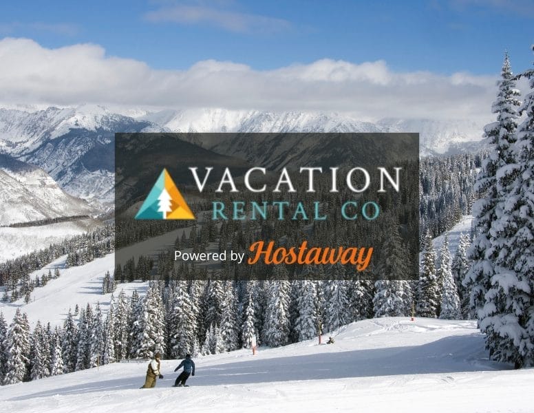 A snowy mountain landscape with a few skiers descending a slope. Snow-covered pine trees frame the scene. An overlay shows the text: "VACATION RENTAL CO Powered by Hostaway.