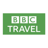 The image shows the BBC Travel logo. It features the letters "BBC" in white, each in a separate square, above the word "TRAVEL" in white, all set against a green rectangular background.