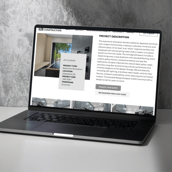 A laptop on a desk displays an architectural project description for a basement renovation, including modern design images and text details. The background features a light-colored wall, creating a minimalist setting.